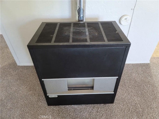 904 Toomes Ave, Corning, CA 96021 - detailed view of heating unit, baseboards, and carpet flooring