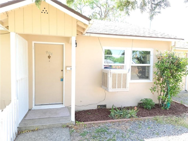904 Toomes Ave, Corning, CA 96021 - view of exterior entry featuring a shingled roof, cooling unit, and stucco siding