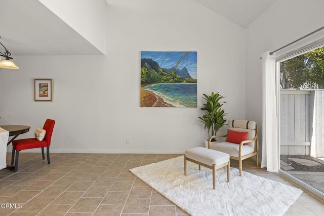 sitting room with tile patterned flooring, baseboards, and lofted ceiling