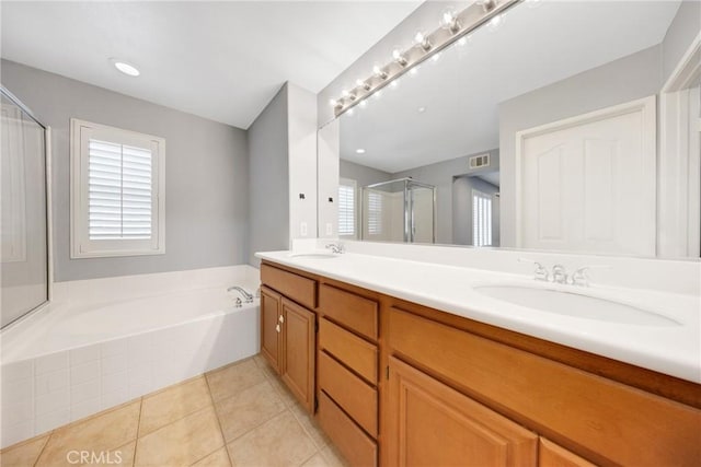 full bath with a sink, tile patterned flooring, a stall shower, and a bath