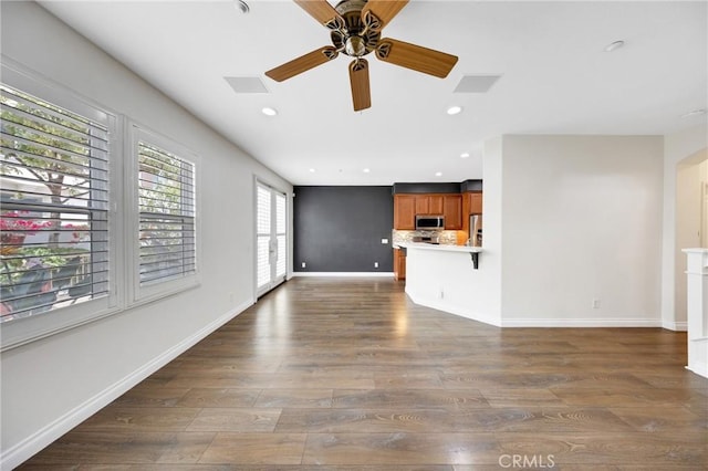 unfurnished living room featuring dark wood-style flooring, ceiling fan, and recessed lighting
