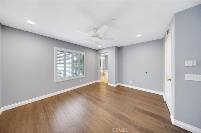empty room featuring visible vents, wood finished floors, baseboards, ceiling fan, and recessed lighting
