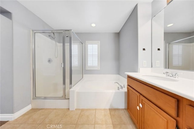 full bathroom featuring vanity, tile patterned flooring, a bath, and a stall shower