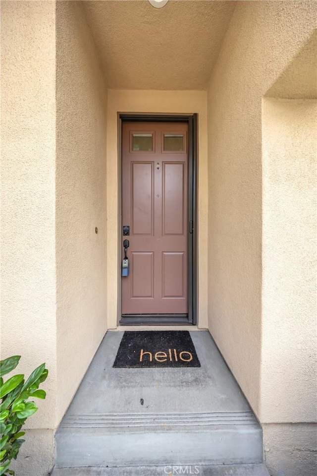 doorway to property with stucco siding