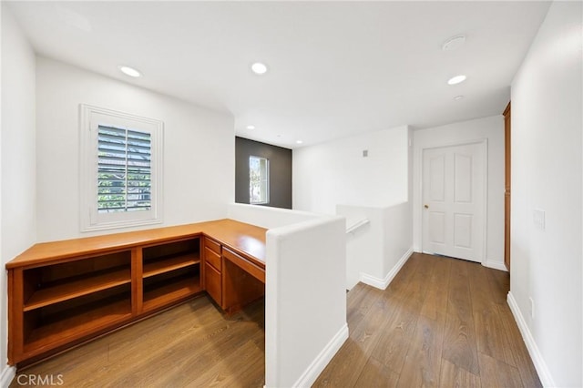 hallway featuring recessed lighting, baseboards, an upstairs landing, and wood finished floors
