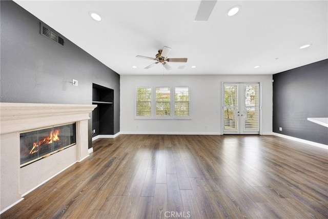 unfurnished living room with a glass covered fireplace, ceiling fan, recessed lighting, and wood finished floors