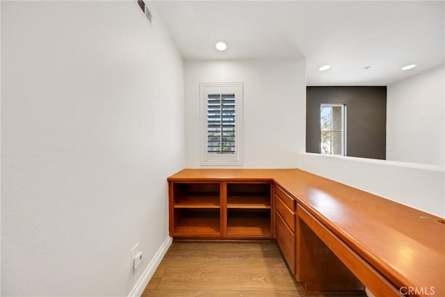 details featuring visible vents, wood finished floors, baseboards, built in study area, and recessed lighting