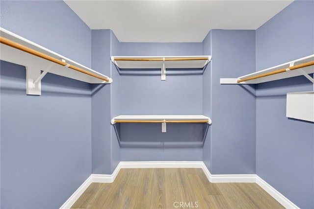 spacious closet with wood finished floors