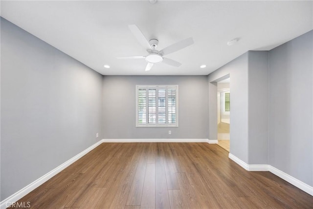 unfurnished room featuring baseboards, a ceiling fan, and wood finished floors