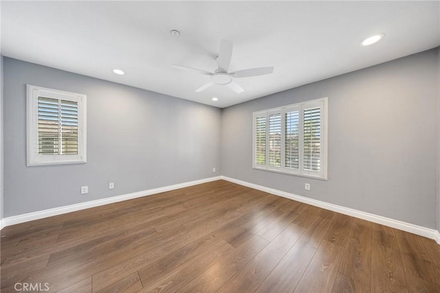 unfurnished room with baseboards, a ceiling fan, and wood finished floors