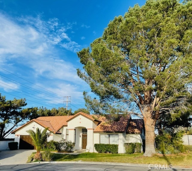 41184 Estates Ln, Palmdale, CA 93551 - mediterranean / spanish home featuring stucco siding, a tiled roof, driveway, and an attached garage