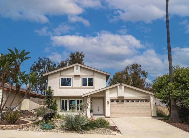 traditional home featuring stucco siding, driveway, and a garage