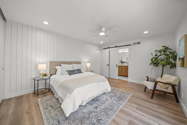 223 Cottingham Ct, Oceanside, CA 92054 - bedroom featuring a barn door, light wood finished floors, baseboards, recessed lighting, and a ceiling fan