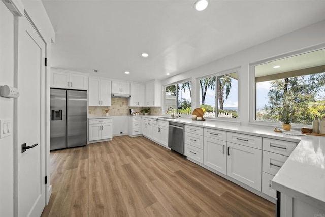 223 Cottingham Ct, Oceanside, CA 92054 - kitchen with appliances with stainless steel finishes, healthy amount of natural light, a sink, white cabinets, and recessed lighting