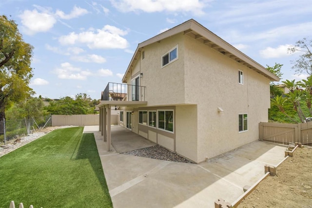 223 Cottingham Ct, Oceanside, CA 92054 - rear view of house with a balcony, stucco siding, a patio area, and a fenced backyard