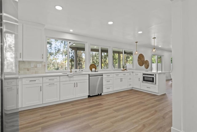 223 Cottingham Ct, Oceanside, CA 92054 - kitchen with stainless steel dishwasher, light wood finished floors, recessed lighting, healthy amount of natural light, and white cabinets