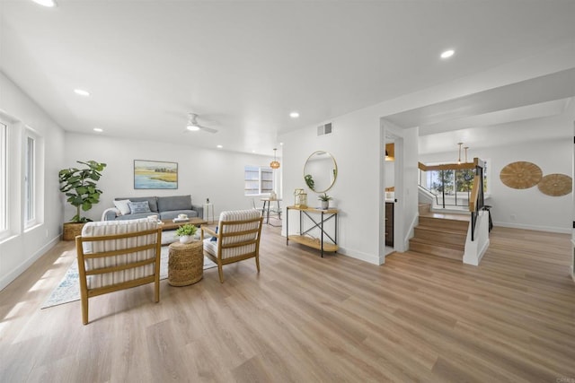 223 Cottingham Ct, Oceanside, CA 92054 - living room with light wood finished floors, ceiling fan, stairway, and recessed lighting