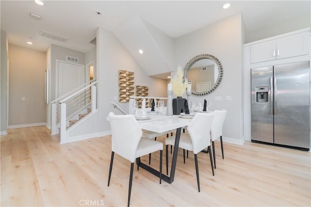 dining space featuring baseboards, visible vents, and light wood-style flooring