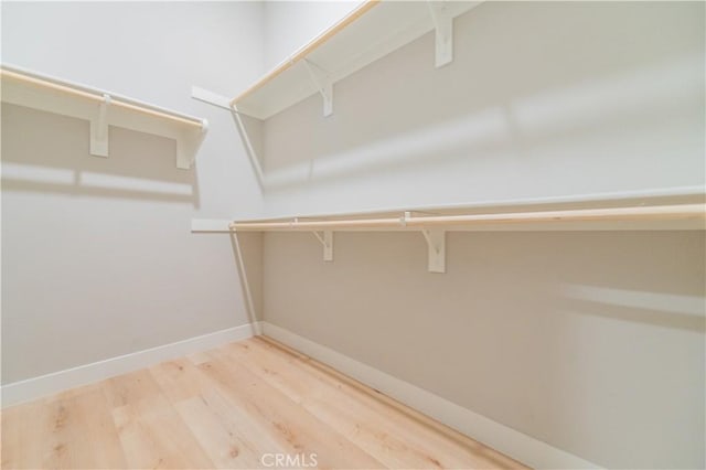 spacious closet with wood finished floors