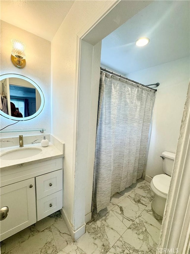 248 E Washington Blvd Unit 10, Pasadena, CA 91104 - bathroom with marble finish floors, toilet, vanity, and baseboards