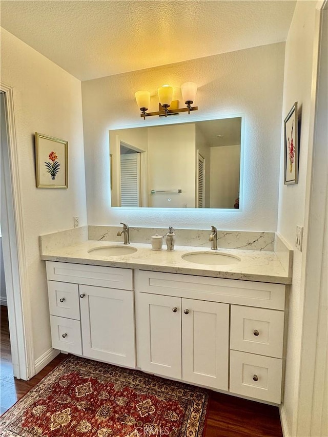 248 E Washington Blvd Unit 10, Pasadena, CA 91104 - bathroom featuring wood finished floors, double vanity, and baseboards