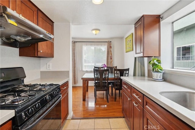 248 E Washington Blvd Unit 10, Pasadena, CA 91104 - kitchen featuring black gas range, under cabinet range hood, light countertops, and light tile patterned floors