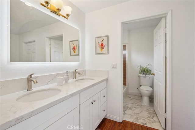 248 E Washington Blvd Unit 10, Pasadena, CA 91104 - bathroom featuring toilet, double vanity, a bath, marble look tile flooring, and baseboards