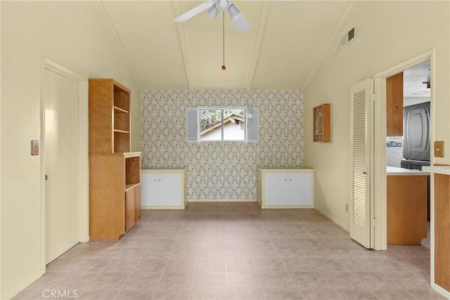 additional living space featuring a ceiling fan, lofted ceiling, wallpapered walls, and visible vents