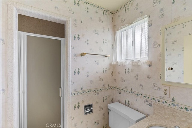 bathroom featuring vanity, a stall shower, and toilet