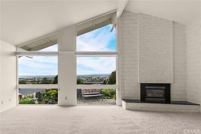 interior space with a fireplace, carpet floors, floor to ceiling windows, and lofted ceiling with beams