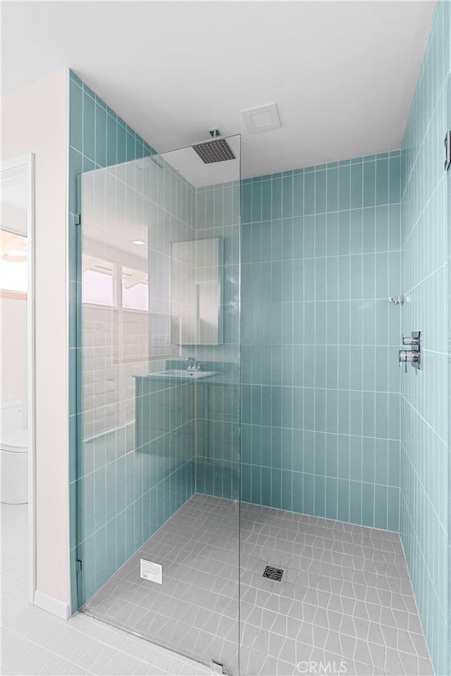 full bath with tile patterned floors, a stall shower, and toilet