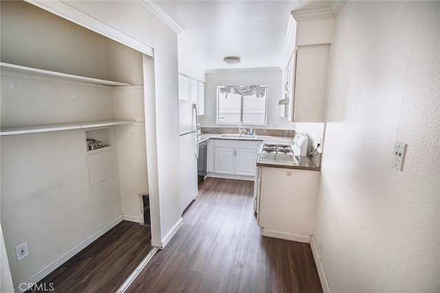 corridor with baseboards, a sink, dark wood-style flooring, and ornamental molding