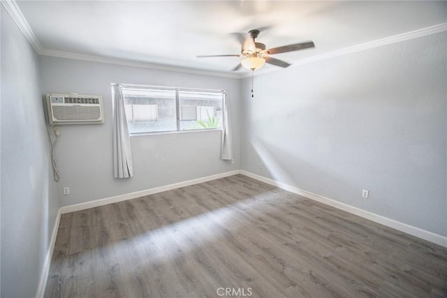 spare room with a ceiling fan, baseboards, ornamental molding, and wood finished floors