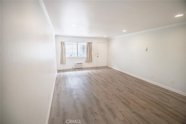 spare room with crown molding and baseboards