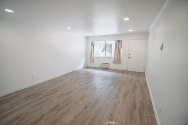 unfurnished room featuring crown molding, recessed lighting, baseboards, and light wood-style floors