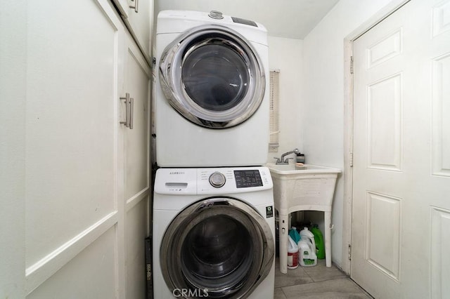 1125 W 129th St, Gardena, CA 90247 - clothes washing area with laundry area, light tile patterned floors, and stacked washer and clothes dryer