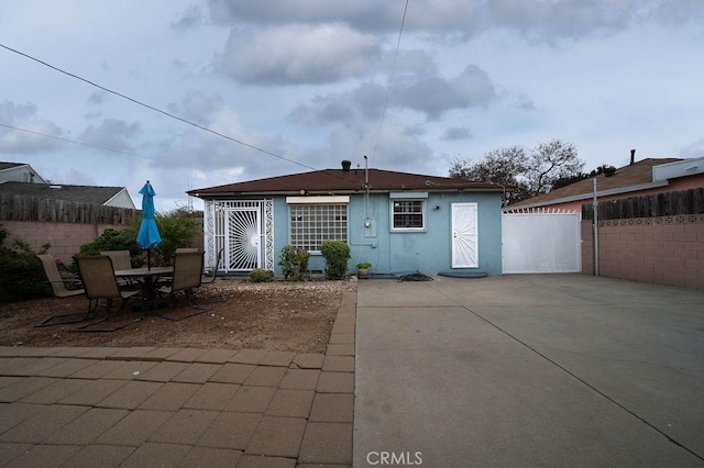 1125 W 129th St, Gardena, CA 90247 - rear view of house with a patio area, stucco siding, and fence