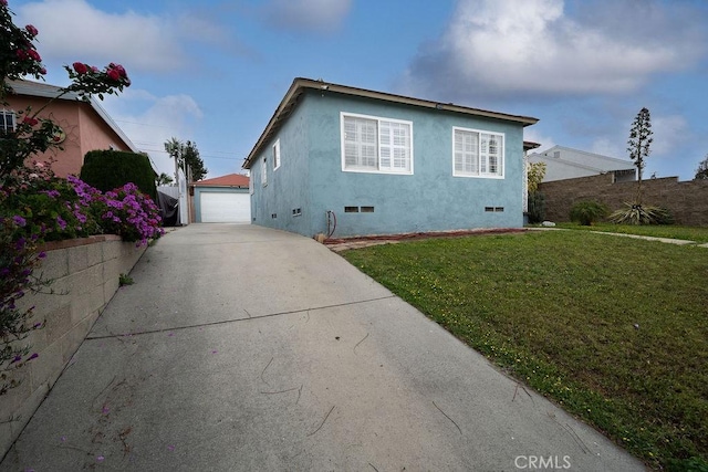 1125 W 129th St, Gardena, CA 90247 - view of property exterior featuring a garage, stucco siding, a yard, crawl space, and an outbuilding