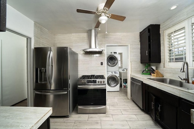 1125 W 129th St, Gardena, CA 90247 - kitchen featuring a sink, light countertops, ventilation hood, stacked washer and clothes dryer, and stainless steel appliances