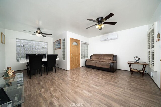 1125 W 129th St, Gardena, CA 90247 - living area featuring ceiling fan, a wall mounted AC, and wood finished floors
