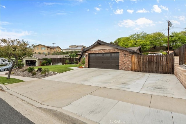 1131 Saint George Dr, San Dimas, CA 91773 - view of front of home featuring a garage, fence, a front yard, brick siding, and concrete driveway