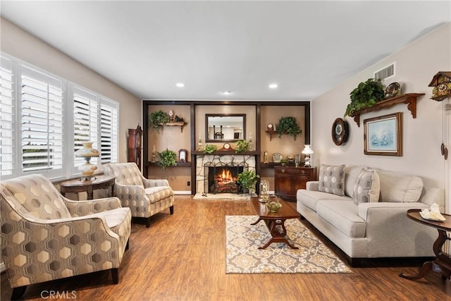 1131 Saint George Dr, San Dimas, CA 91773 - living area with recessed lighting, a warm lit fireplace, visible vents, and wood finished floors
