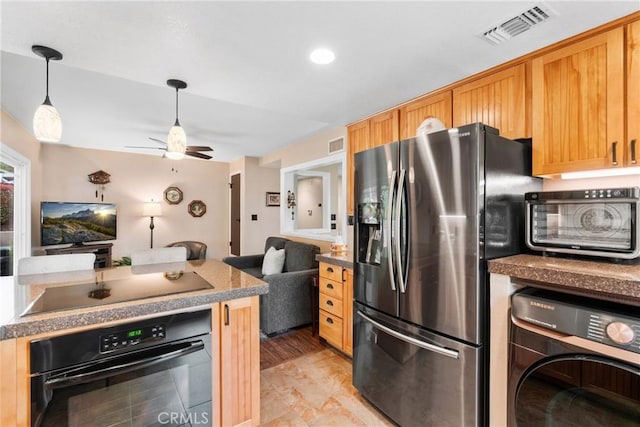 1131 Saint George Dr, San Dimas, CA 91773 - kitchen with ceiling fan, open floor plan, washer / dryer, visible vents, and black appliances