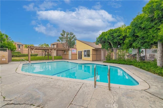 pool with fence, a pergola, and a patio area