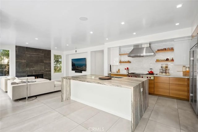 3 Bridgeport Rd, Newport Coast, CA 92657 - kitchen featuring open shelves, stainless steel gas cooktop, wall chimney exhaust hood, light tile patterned floors, and modern cabinets
