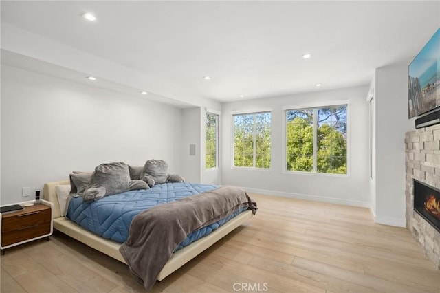 3 Bridgeport Rd, Newport Coast, CA 92657 - bedroom featuring baseboards, recessed lighting, light wood-style flooring, and a fireplace