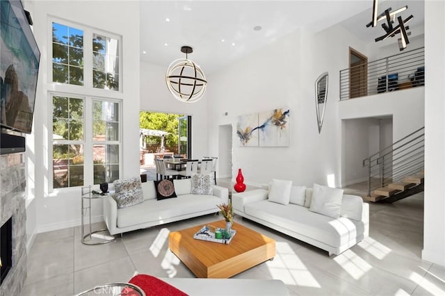 3 Bridgeport Rd, Newport Coast, CA 92657 - tiled living area featuring baseboards, stairs, a high ceiling, and a fireplace
