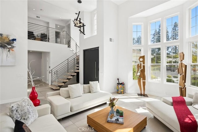 3 Bridgeport Rd, Newport Coast, CA 92657 - tiled living area with stairway, baseboards, a high ceiling, and visible vents