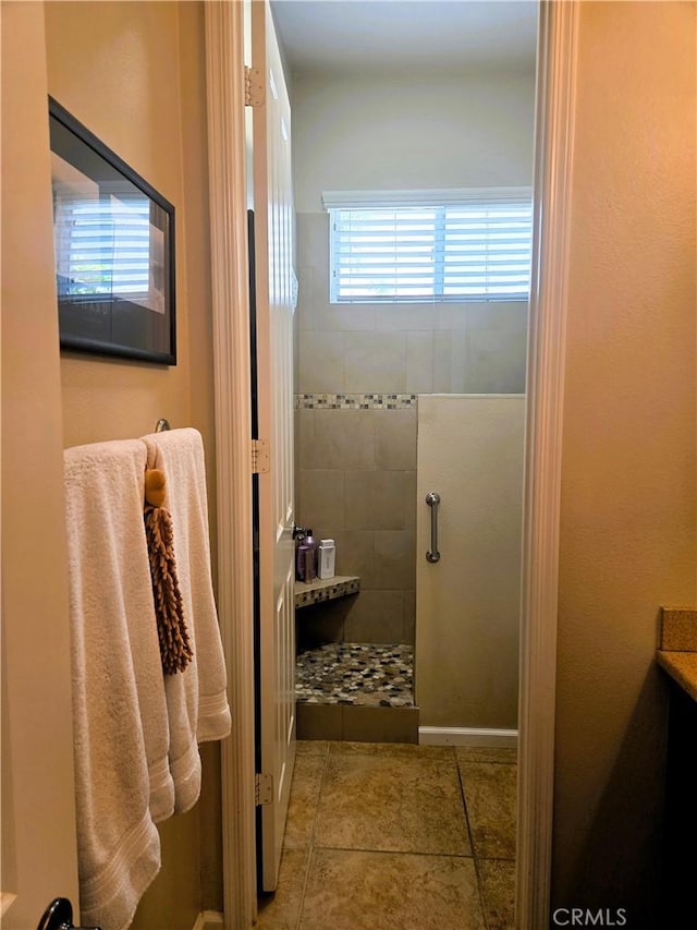 full bath with tile patterned flooring and a walk in shower