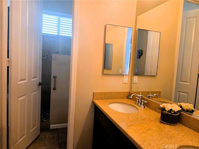 full bathroom featuring a sink, tile patterned flooring, and double vanity